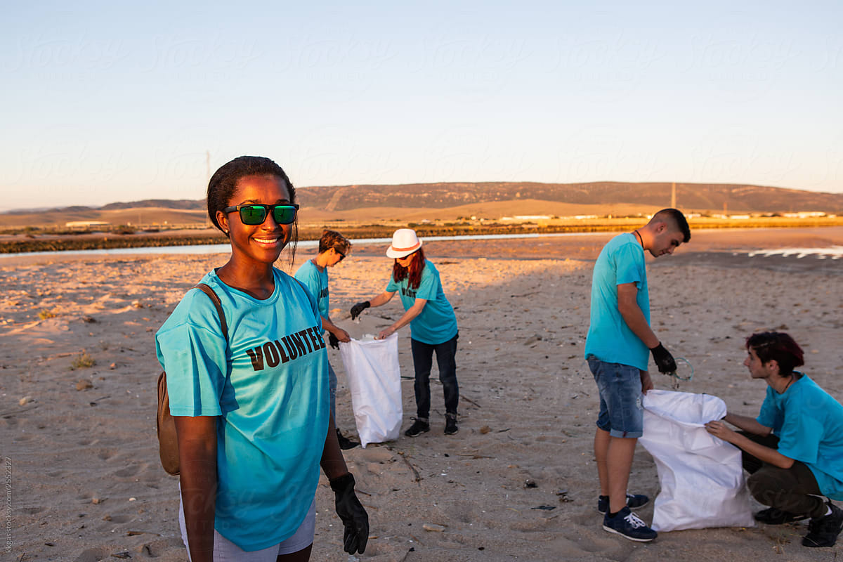 Woman smiling during community  beach clean