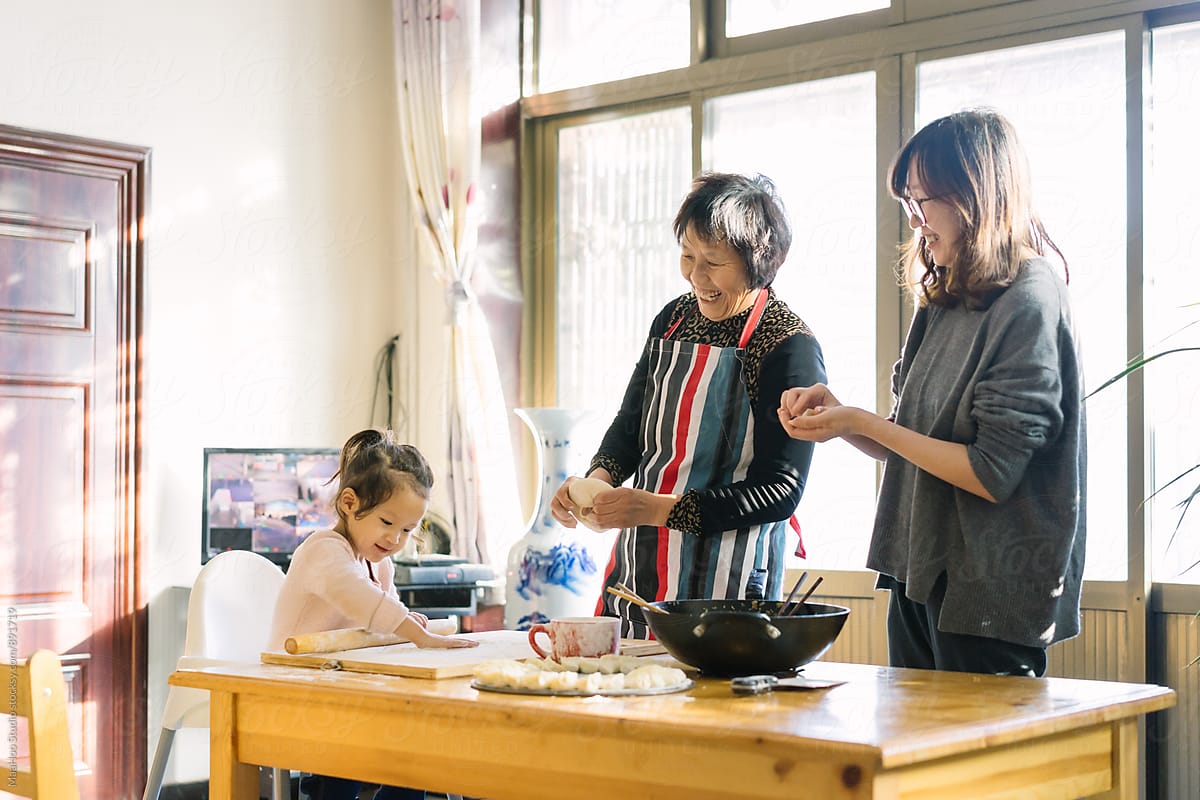 Three generations women making Chinese Dumplings