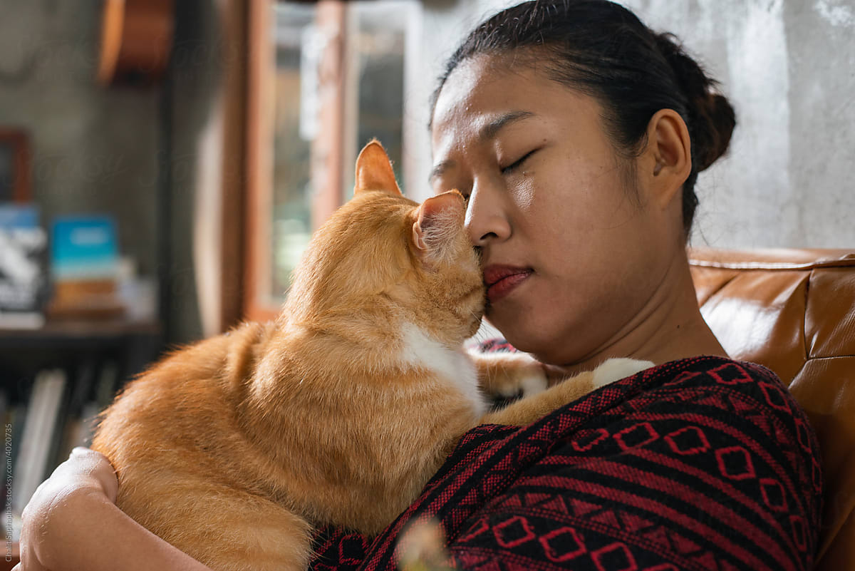Woman hugging a cat