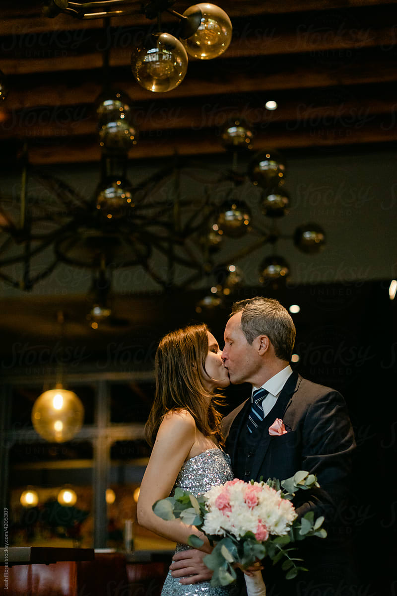 Bride and Groom Kissing in Hotel Lobby