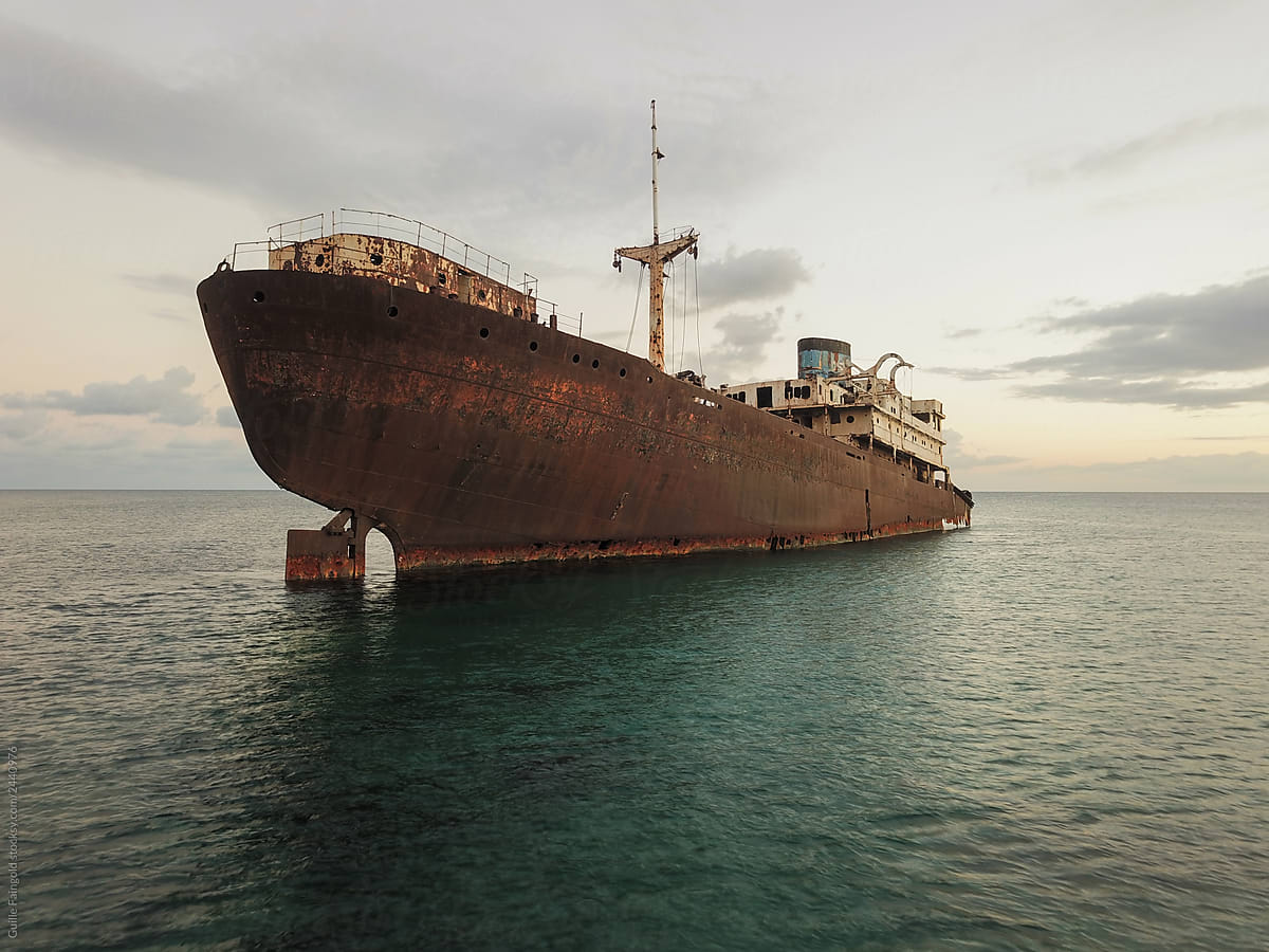 Rusty ship sunken on ocean shoreline