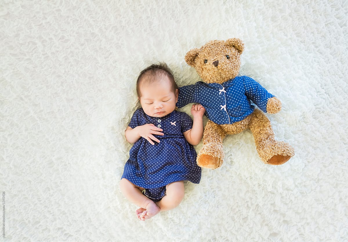 Cute newborn baby portrait with teddy bear
