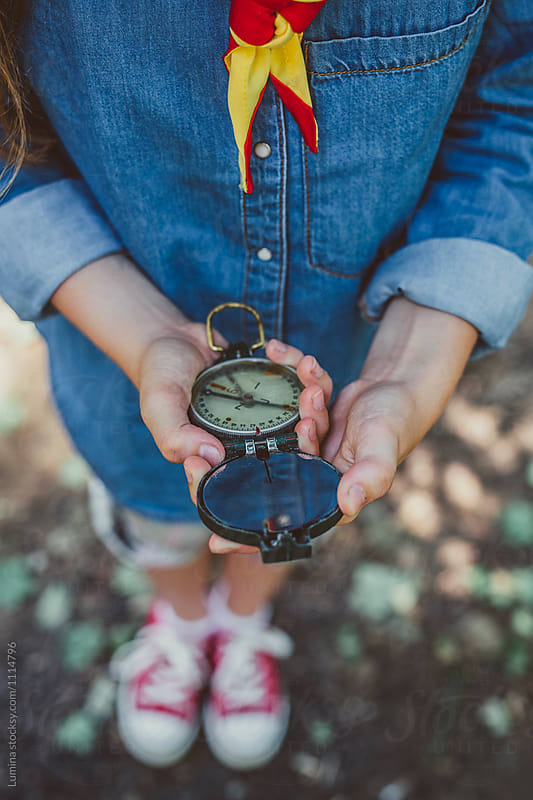 A Girl Scout Holding A Compass