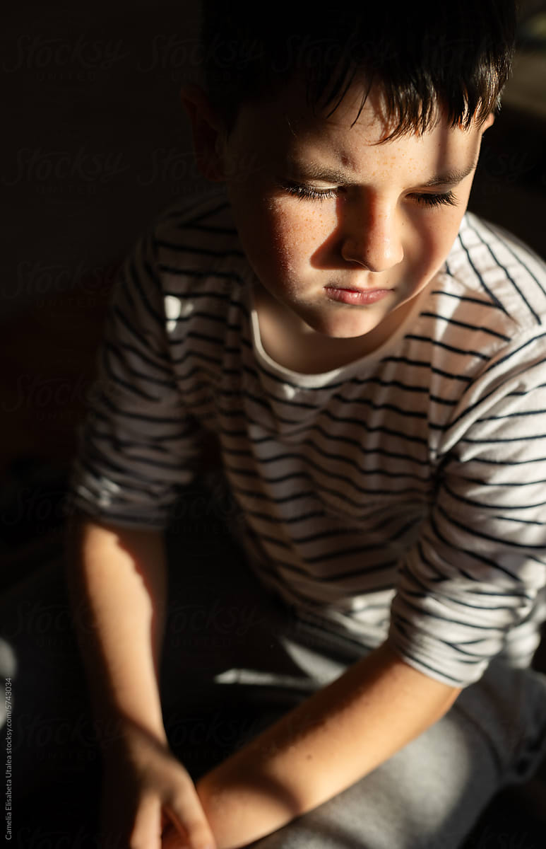 natural light portrait of a boy with freckles