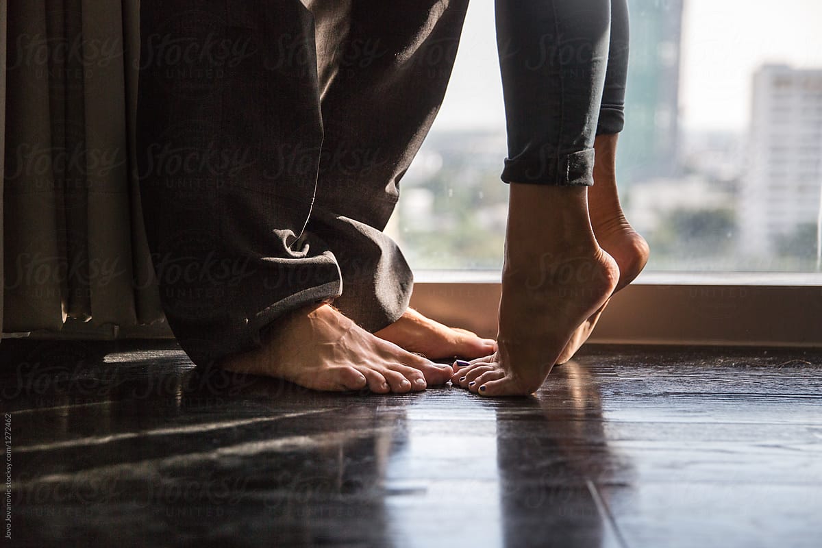 Feet of couple who are kissing