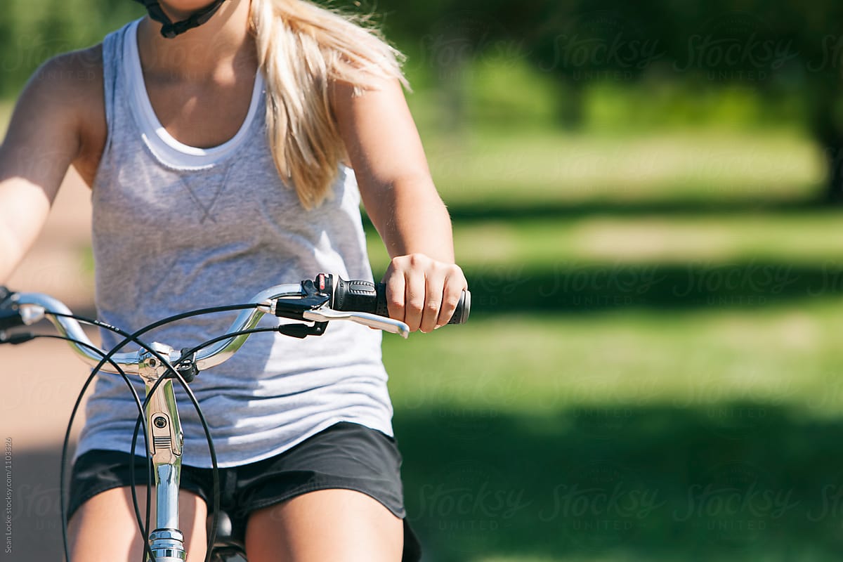 Exercise: Anonymous Woman Riding Bicycle In Park