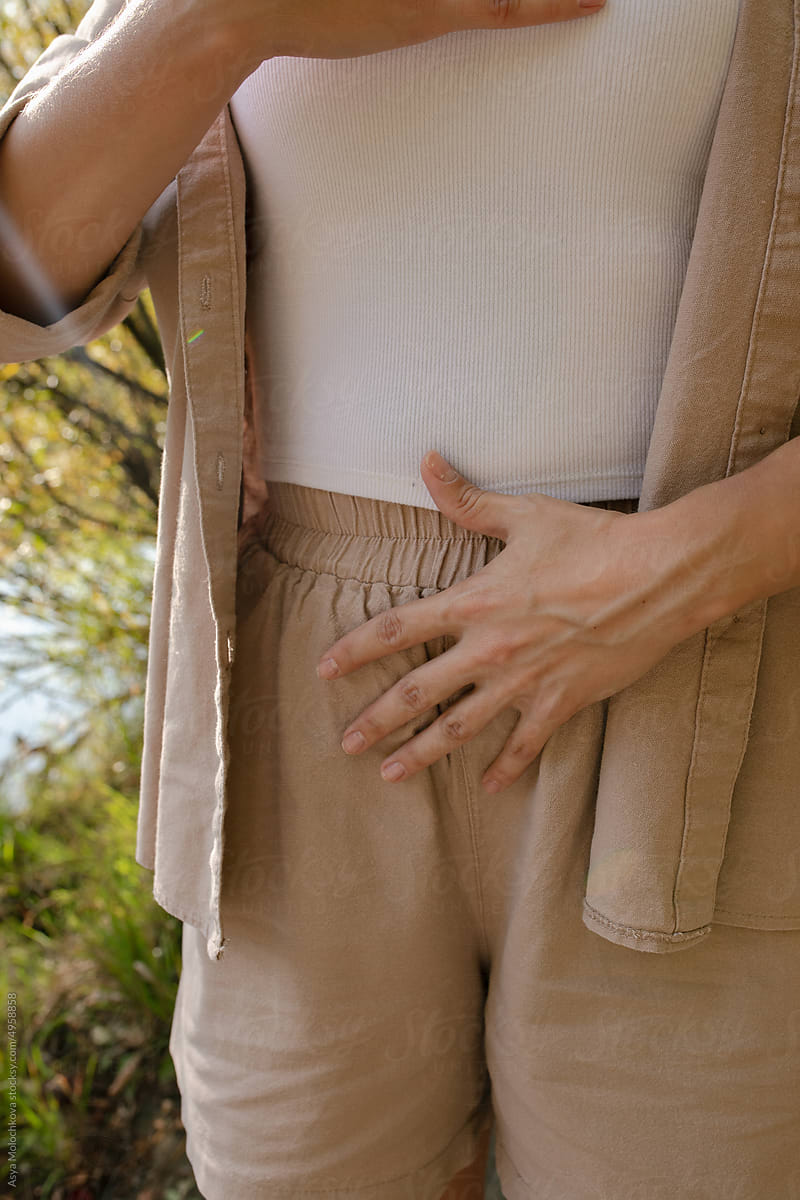 Close-up of hands on chest and stomach while breathing