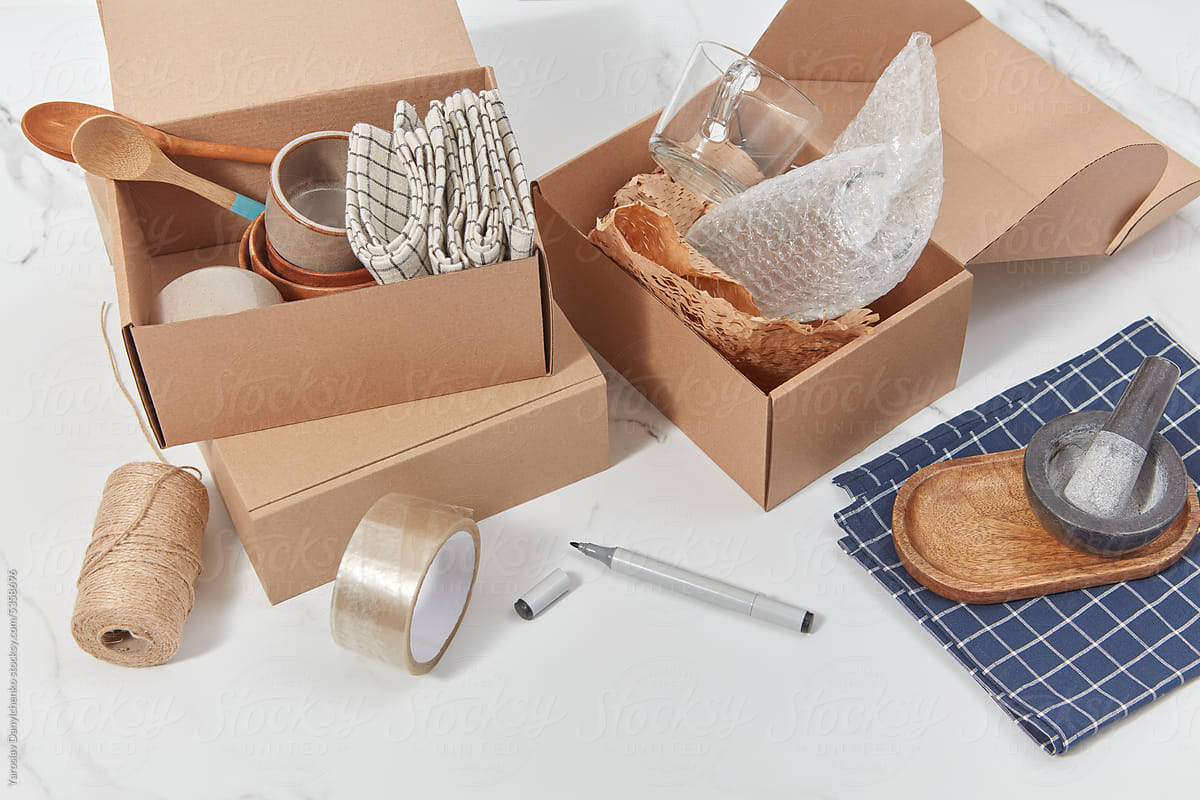 Cardboard boxes with kitchenware and packing materials.