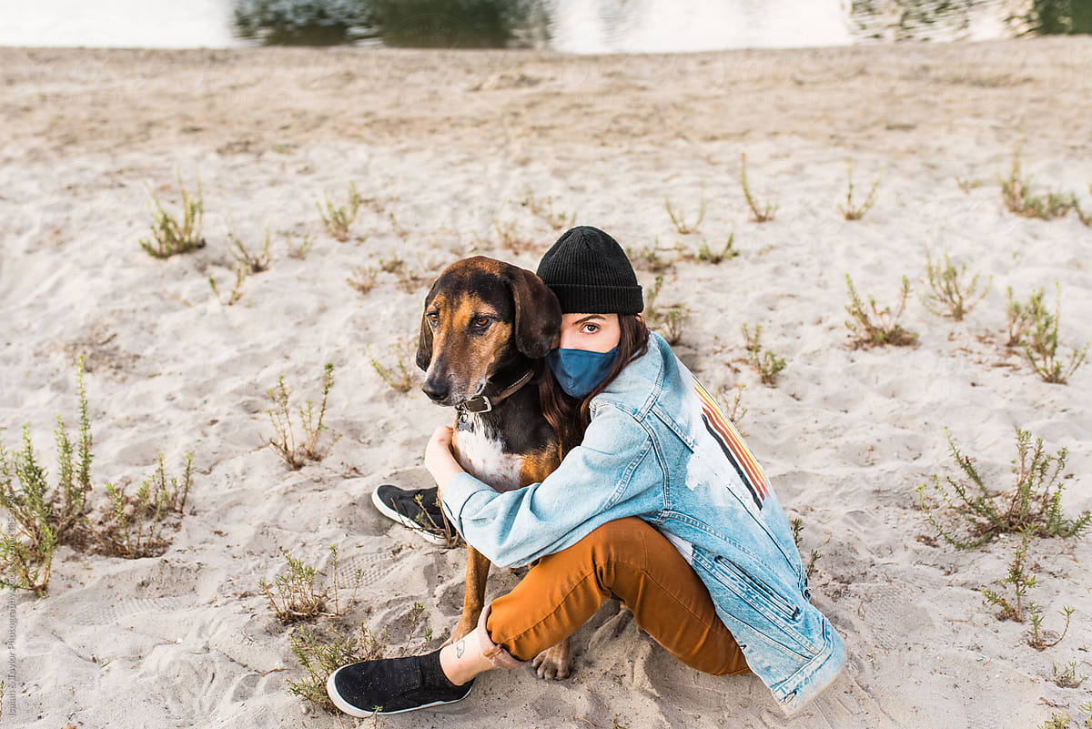 Outdoors in nature with face mask and dog