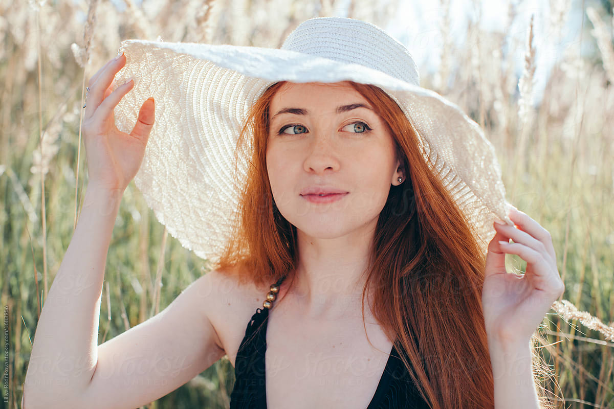 Summer Portrait Of Lovely Redhead Smiling Female Wearing Big Hat By