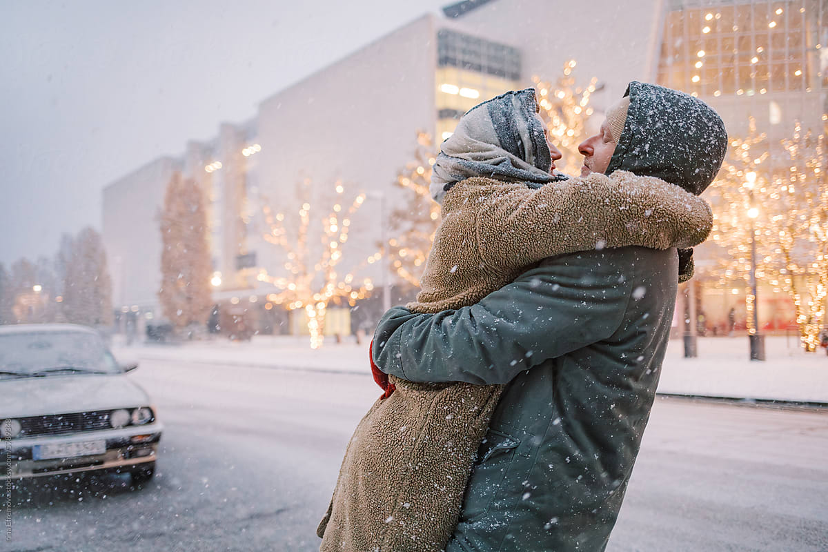 Charming Couple\'s Winter Embrace Lift in Snowfall