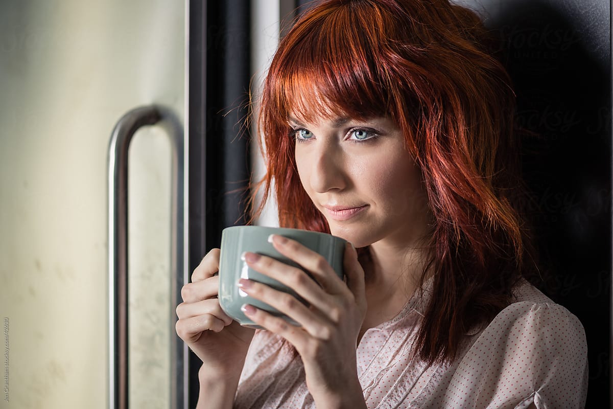 Redhead woman with coffee