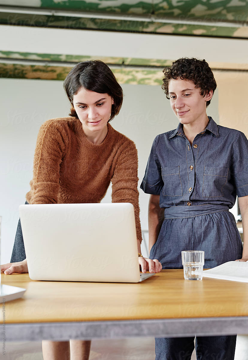Portrait of two women working together in a modern design office.