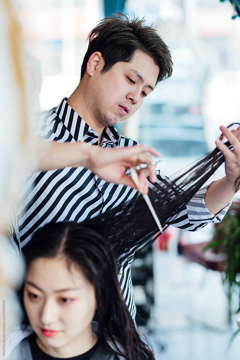 Hairdresser cutting hair in hair salon