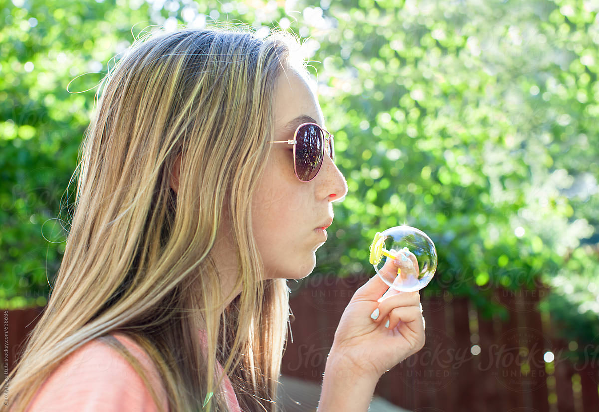 Teenage Girl With Long Blonde Hair And Sunglasses Blowing Bubbles Del Colaborador De Stocksy 