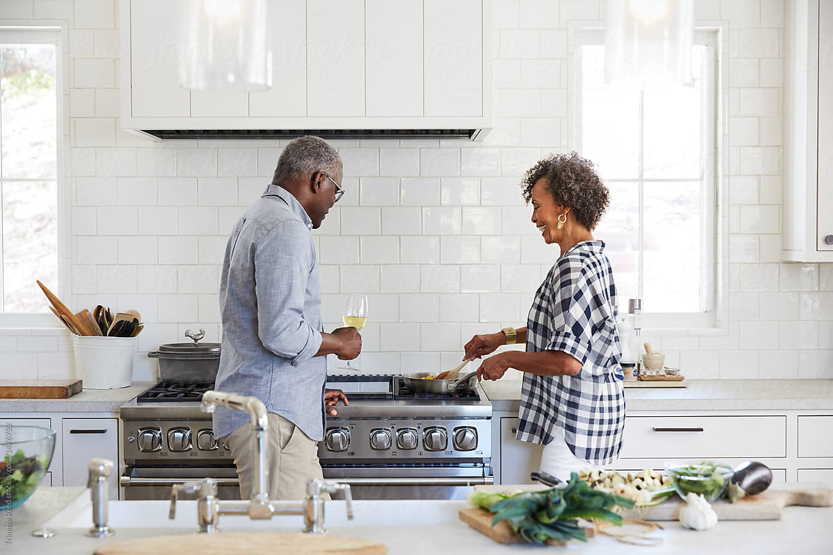 Senior African American couple cooking a meal together in the kitchen