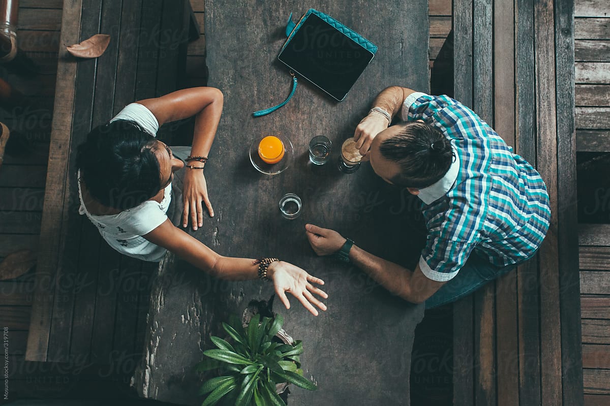 Overhead Shot Of Two Friends In A Cafe By Stocksy Contributor Mosuno