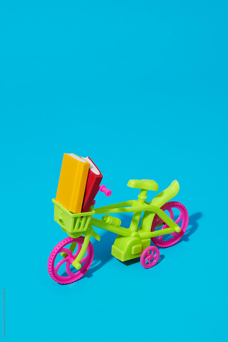 toy bicycle with some books in its basket