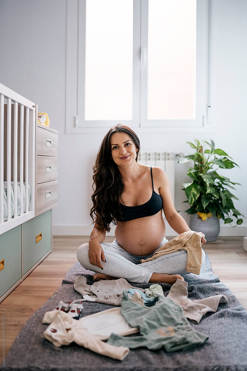 Portrait of smiling pregnant woman at home