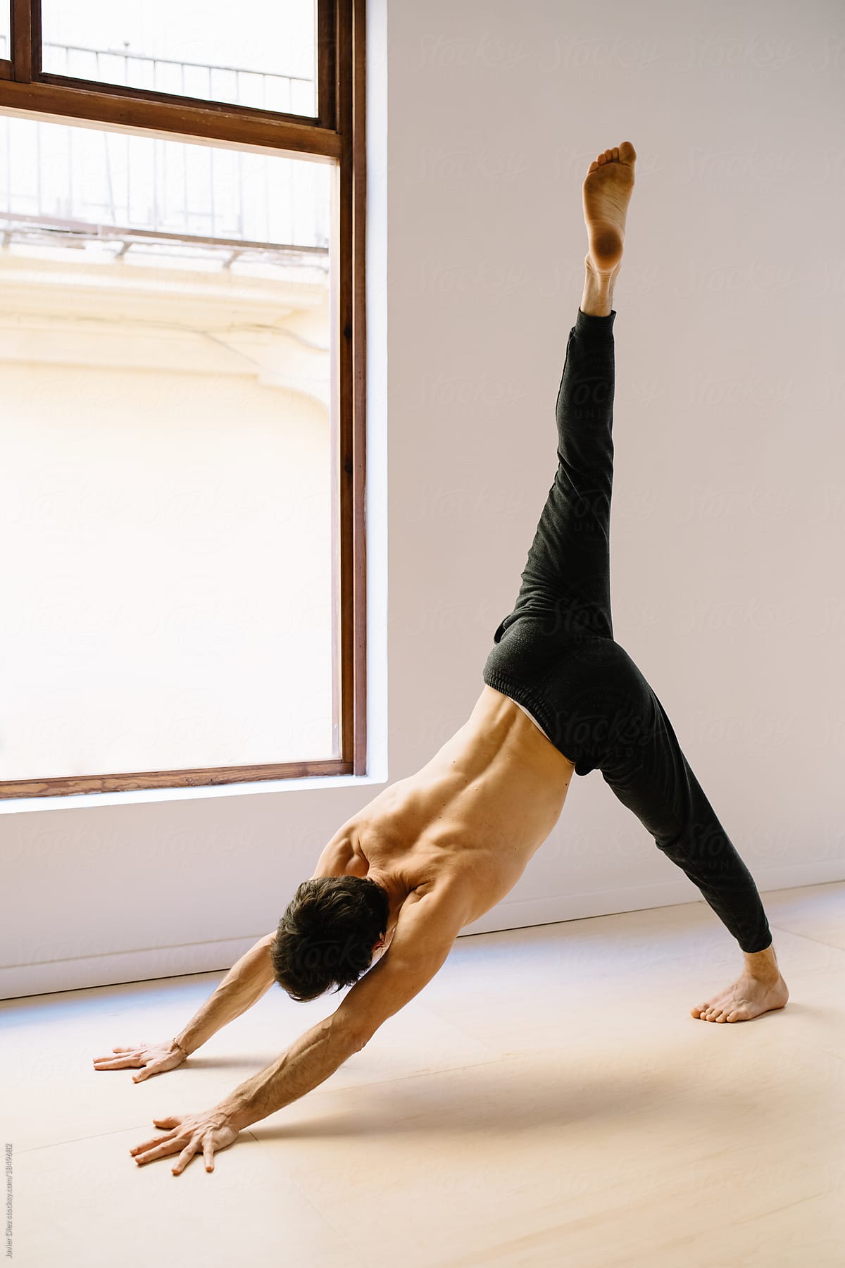Free Photo | Man practicing advanced yoga