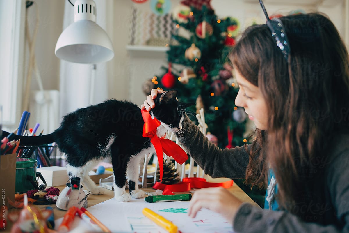 Girl and Her Kitten Writing a Letter to Santa