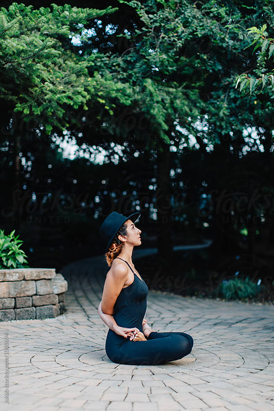 Healthy young woman meditating in full lotus position