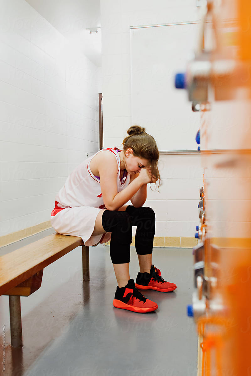 Female Basketball Player Sits On Bench In Locker Room By Tana Teel
