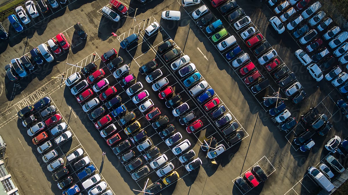 Newly-built cars sit tightly packed awaiting sale