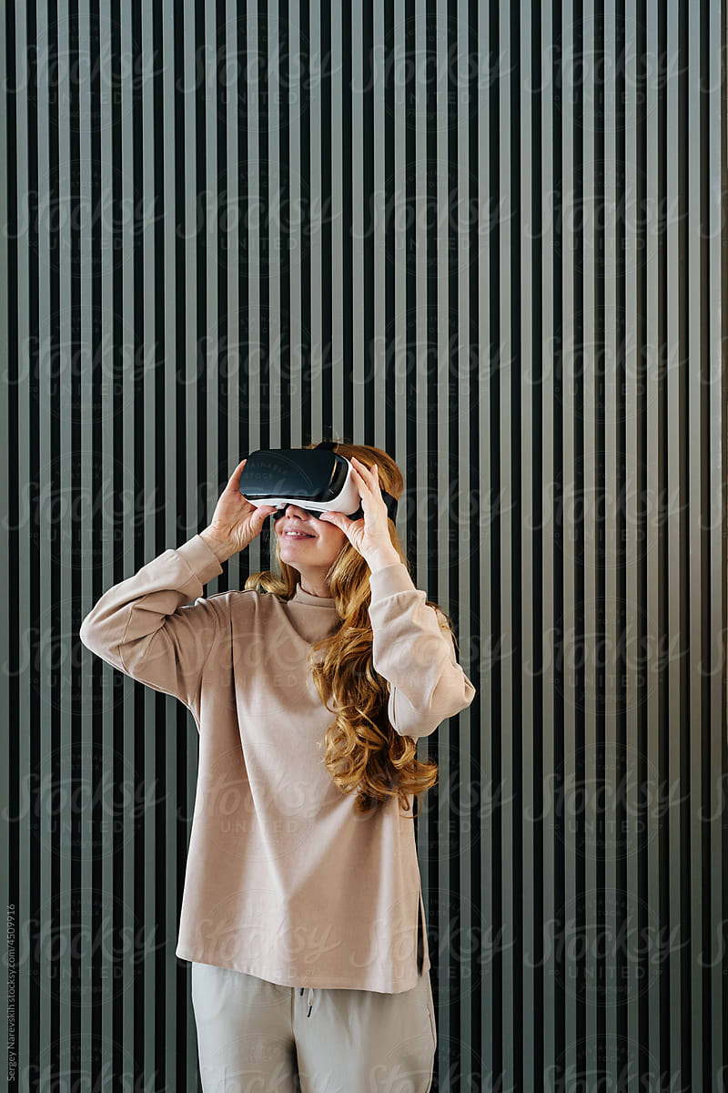 Female in VR helmet near wall