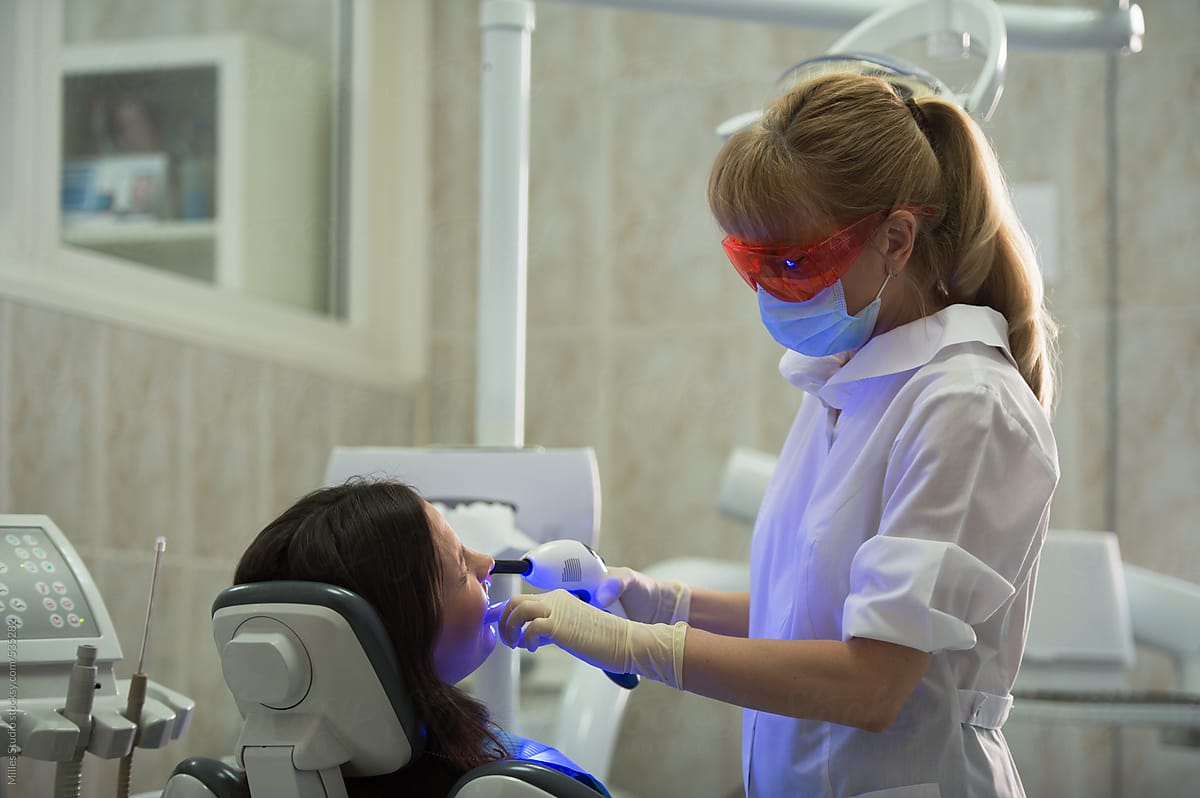 Dentist curing patient