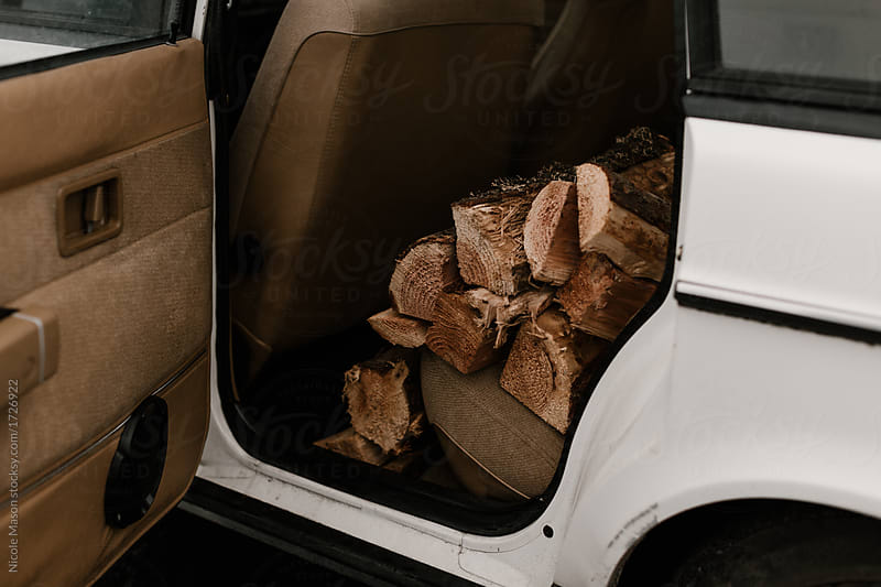 white car with firewood in the back seat