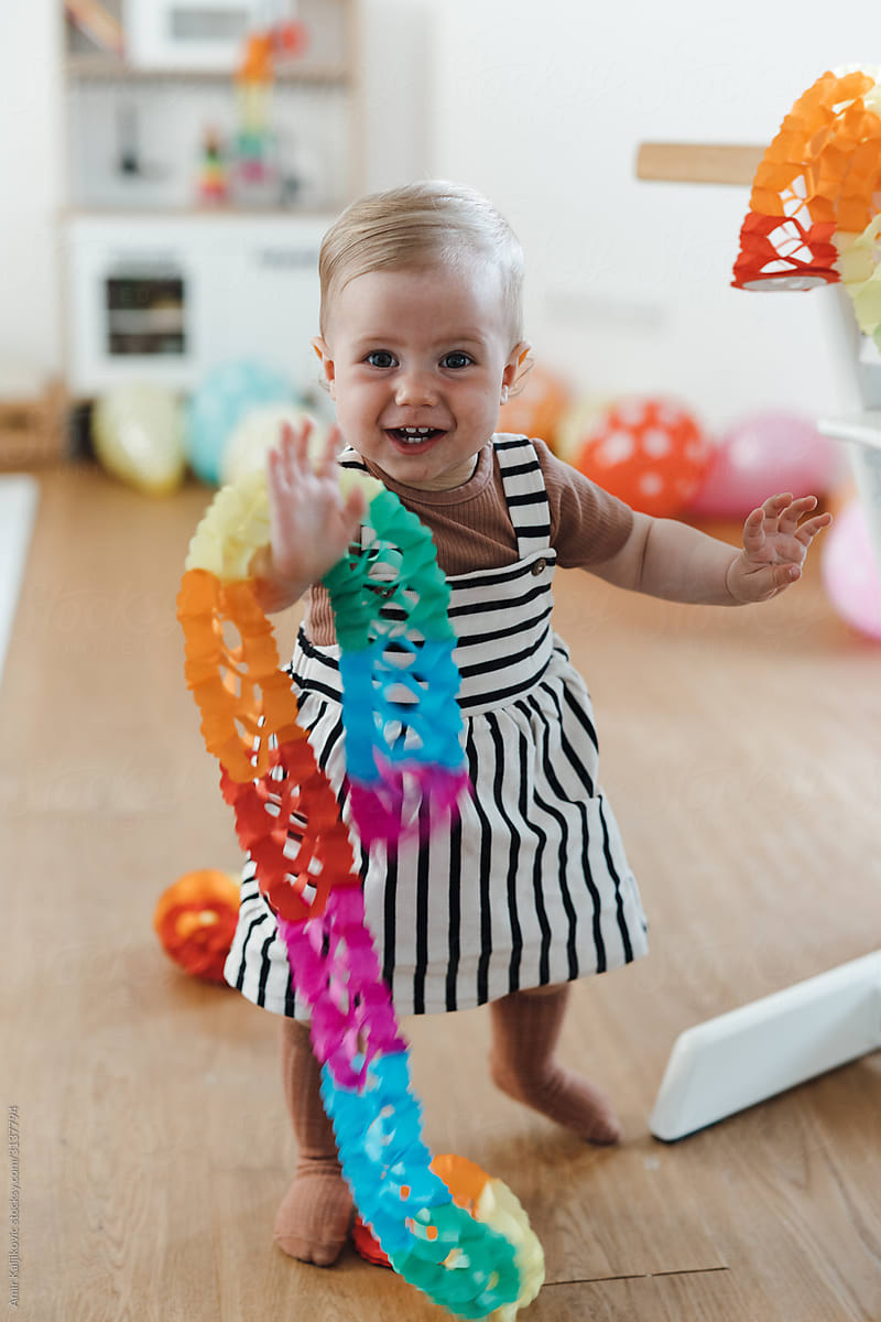 Adorable happy little girl playing with decoration