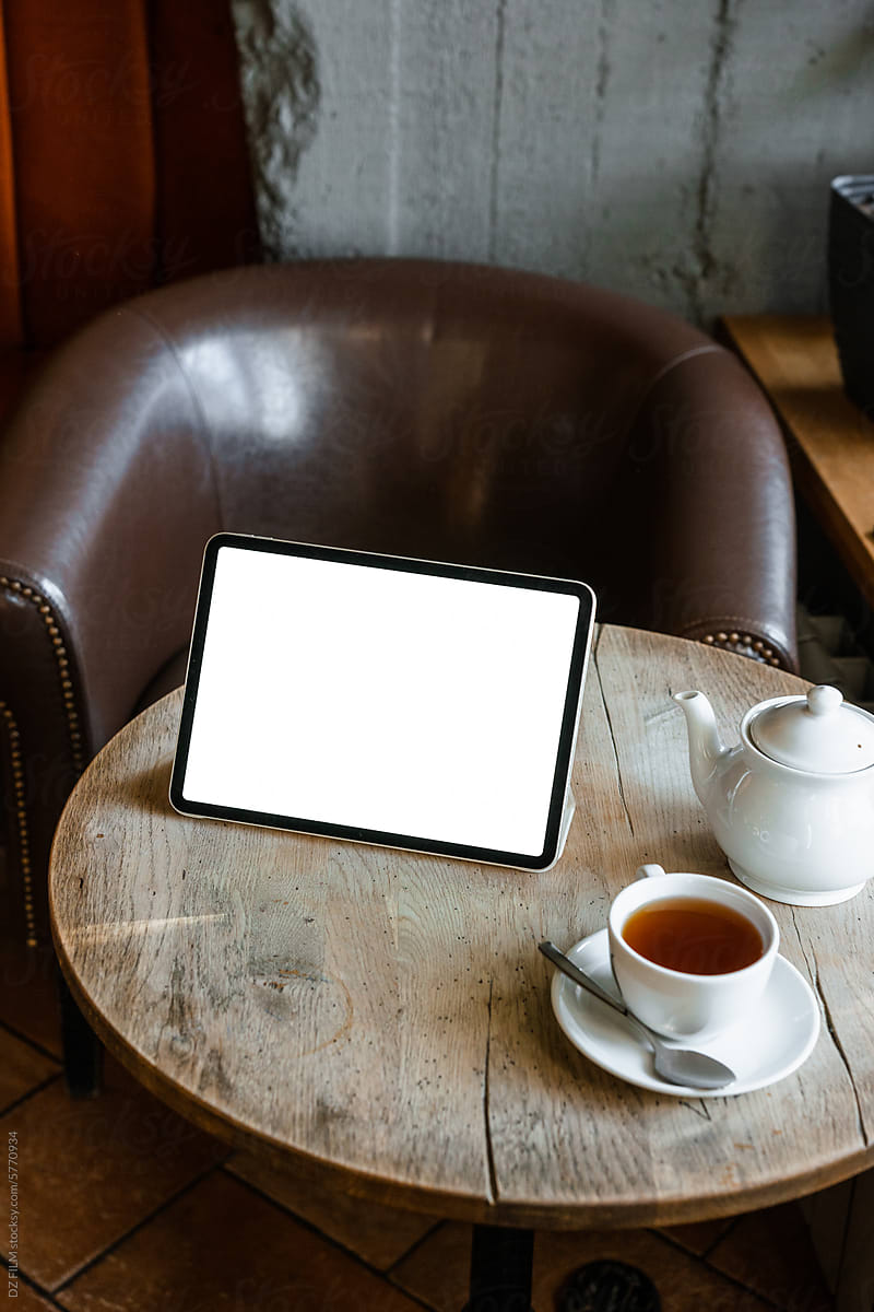 Tablet with white screen on the table