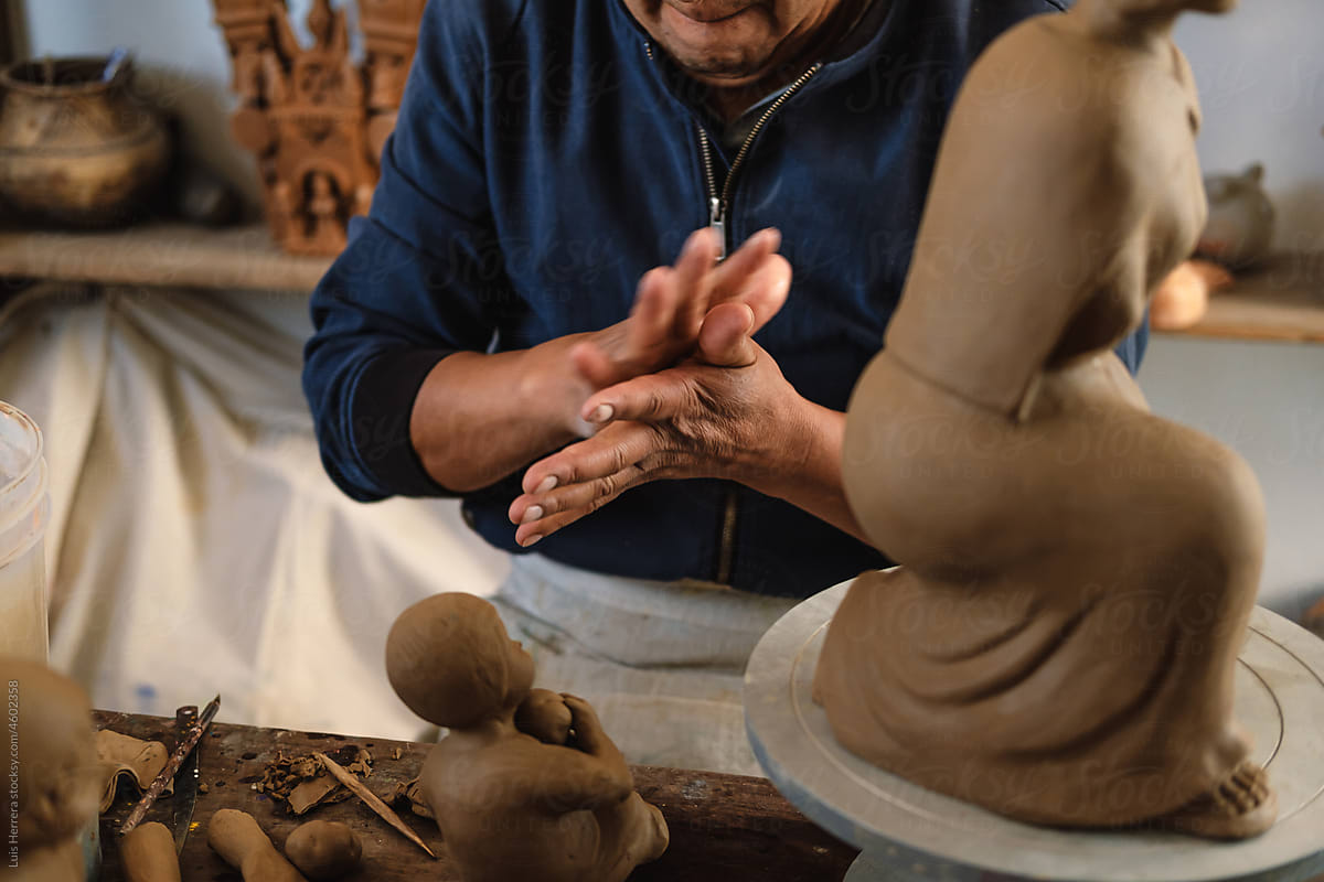 closeup of Artisan  hands Shaping a piece of clay