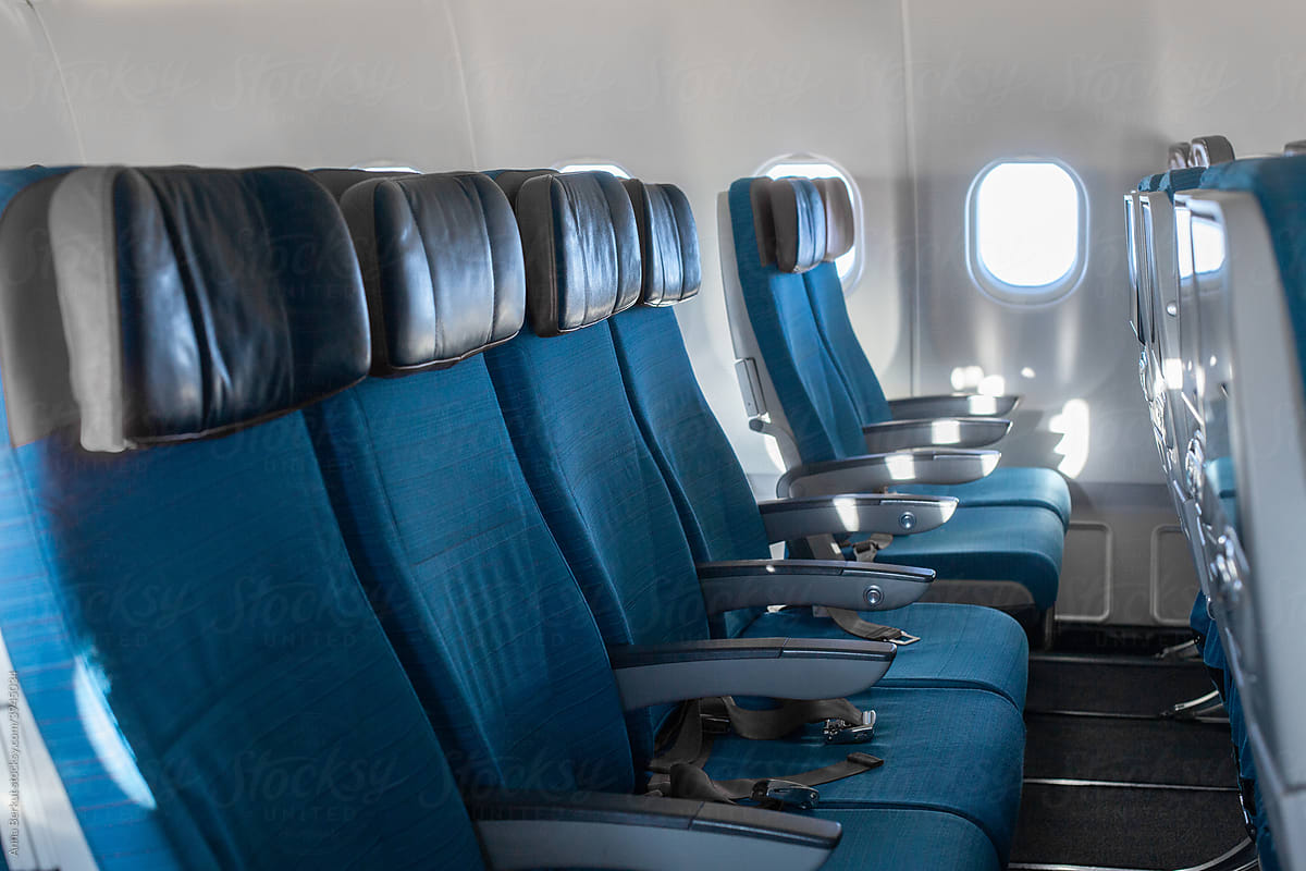 empty airplane interior with blue seat chairs