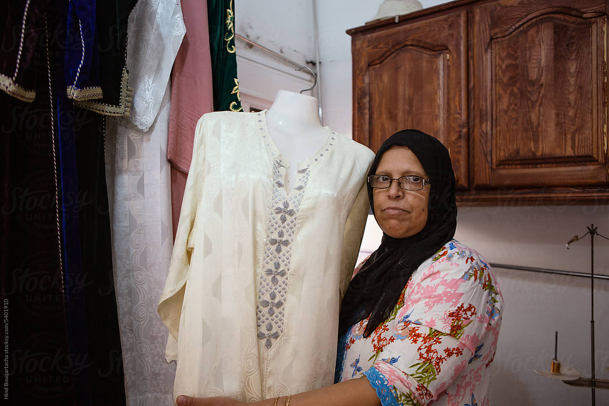 Portrait of a women in her fifties showing her handmade caftan design