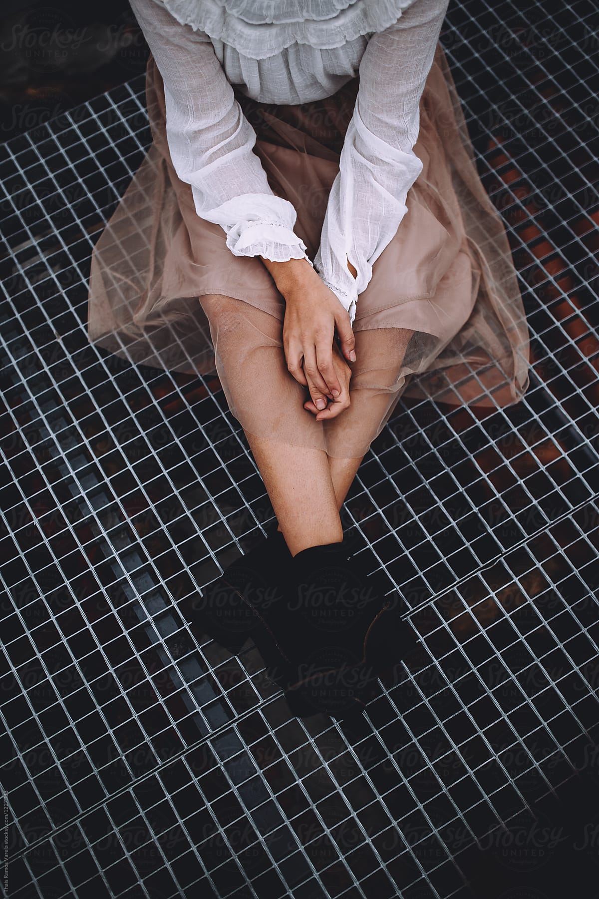woman wearing a pink tulle skirt sitting on the ground