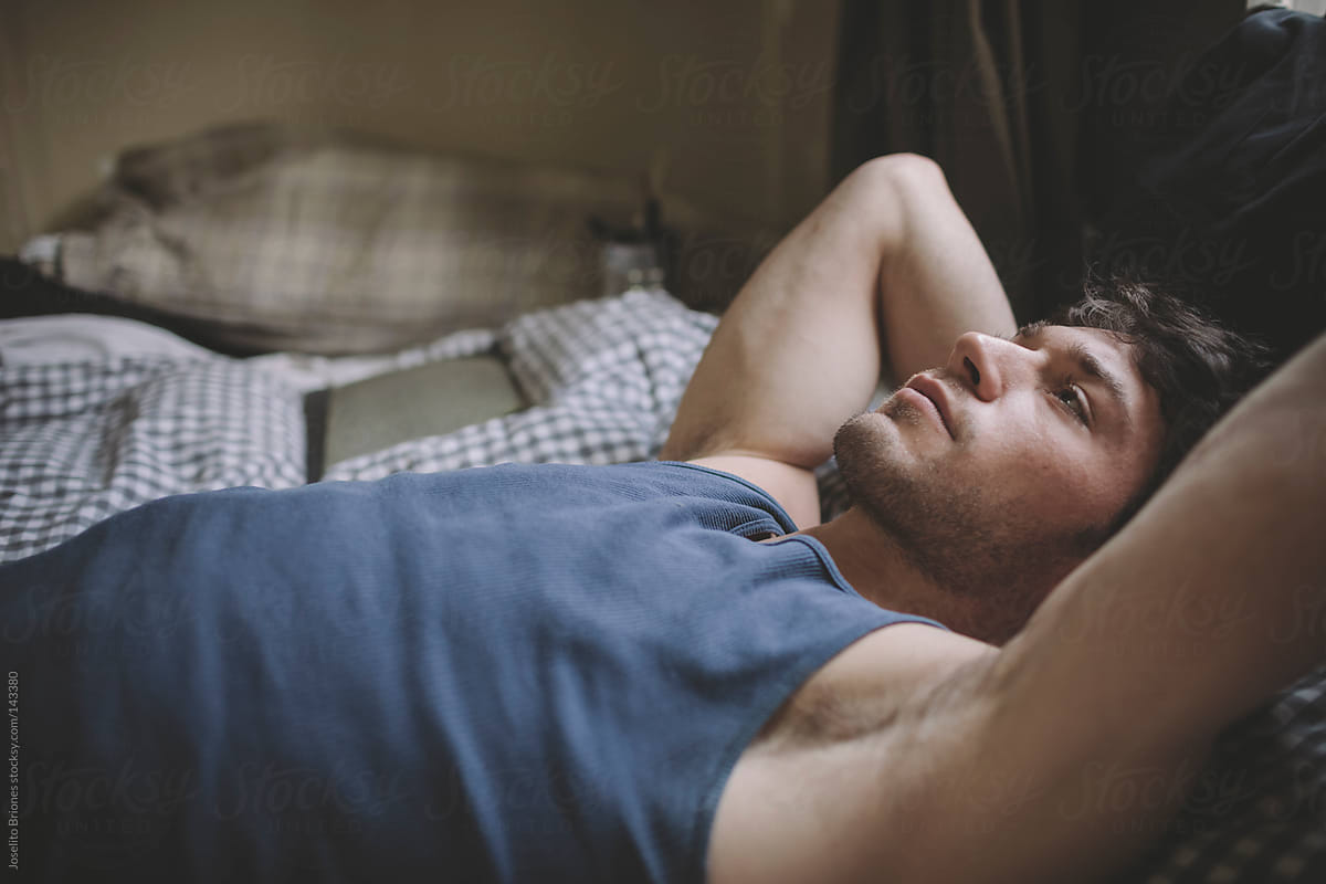Pensive Man Lying in Bed