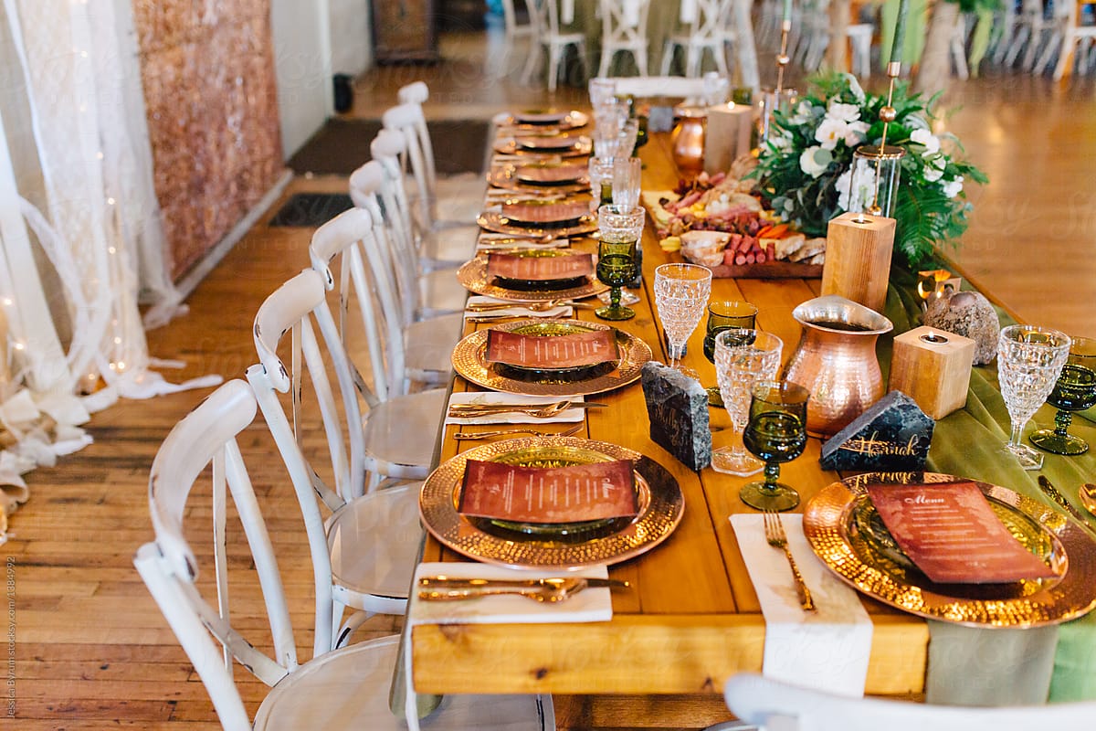 A Venue Set Up For A Wedding Reception With Copper And Green Colored Decor."  by Stocksy Contributor "Jessica Byrum" - Stocksy