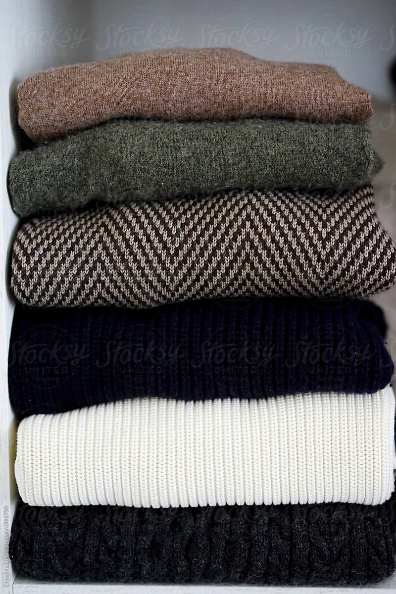 Close-up of stacked textured sweaters