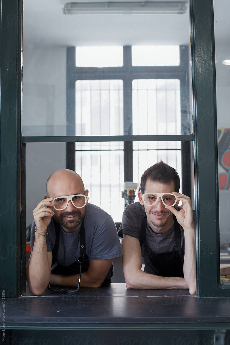 Funny portrait of eyeglasses makers in their own atelier