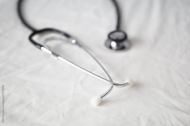 Doctor\'s stethoscope on a hospital bed