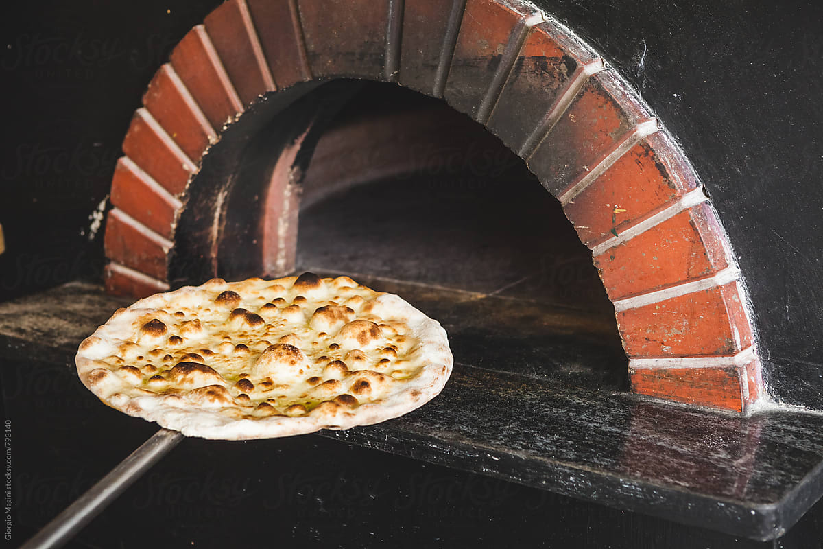Baked Focaccia Pizza in front of a Wood Oven