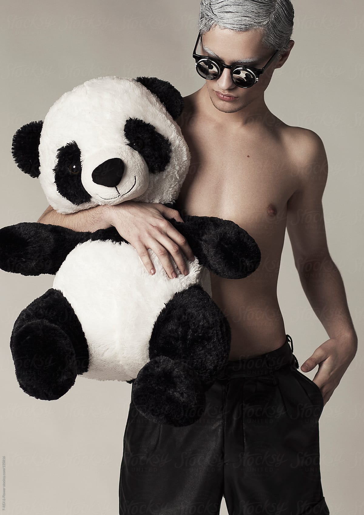 Young man with panda toy