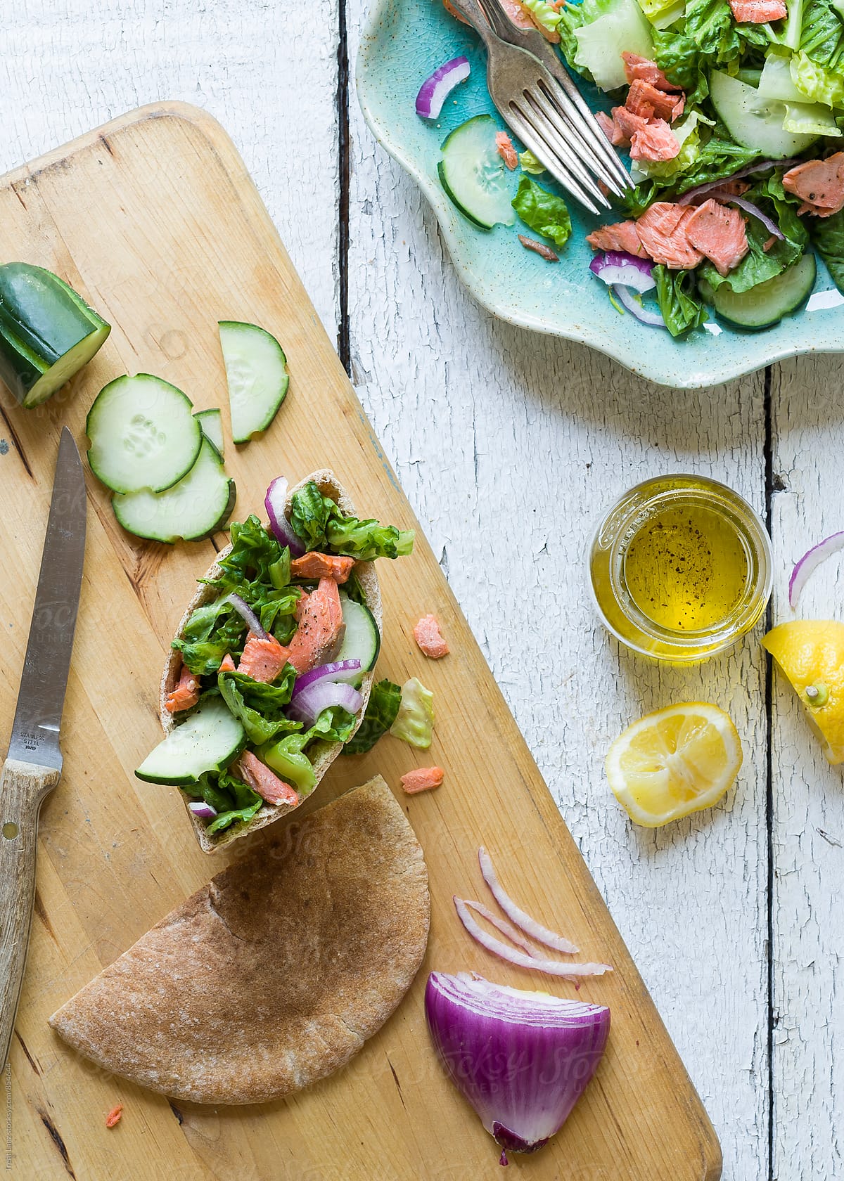 Salmon salad pita sandwich on wooden table