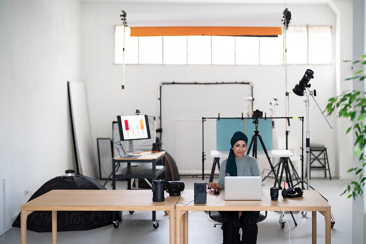 Muslim photographer using laptop in studio