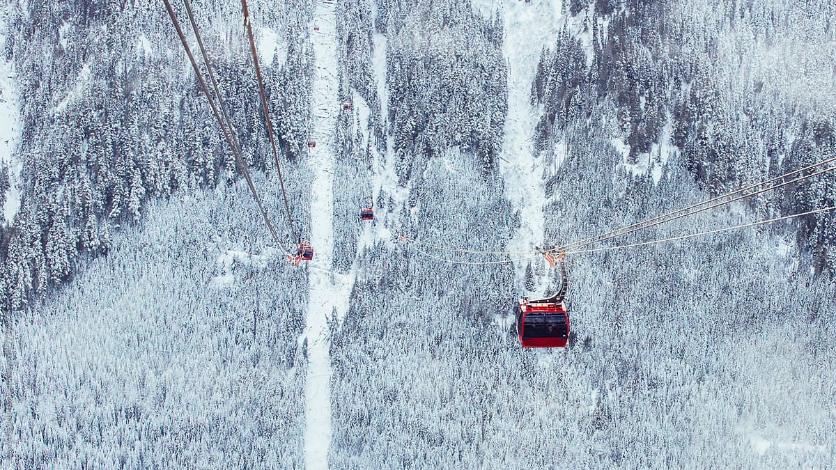 Cable car ride high atop the trees and mountains covered with snow