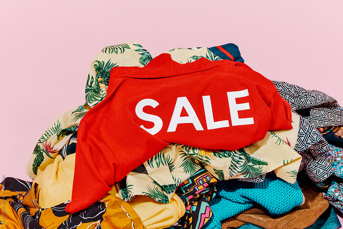 pile of clothes and red shirt with the word sale printed on it