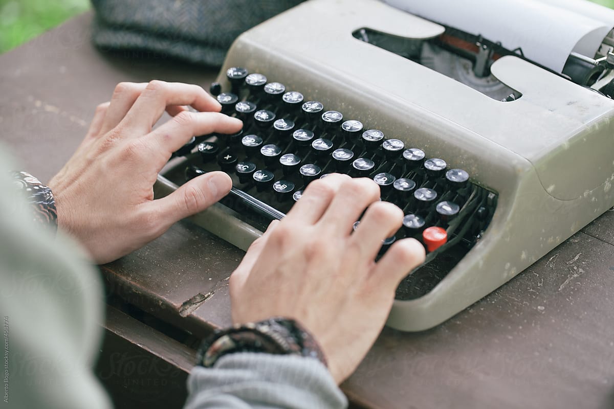 Man working on a typewriter in the garden