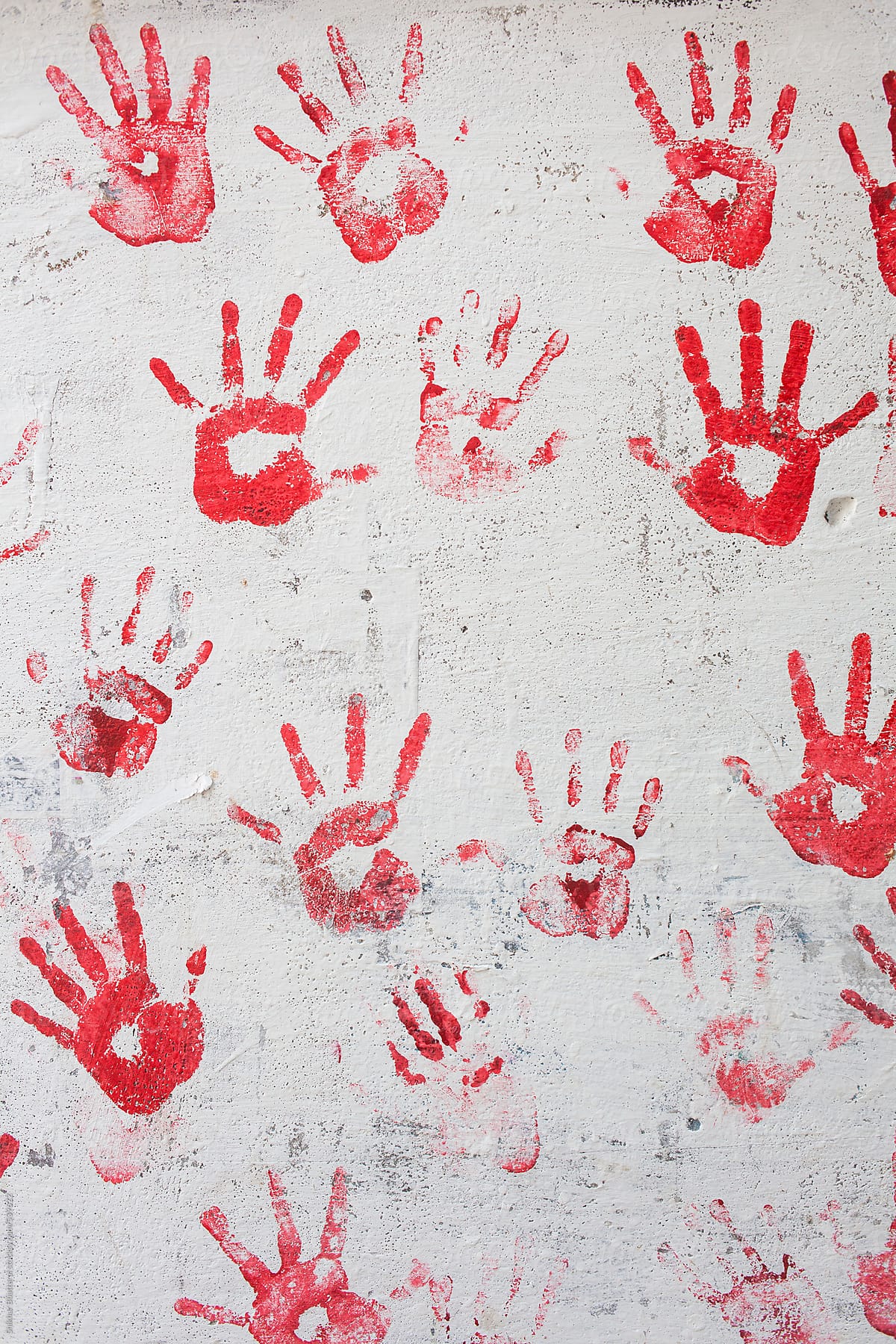 Hand prints on a wall.